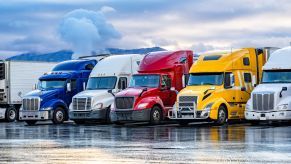 Diesel trucks lined up in a row on a rainy afternoon