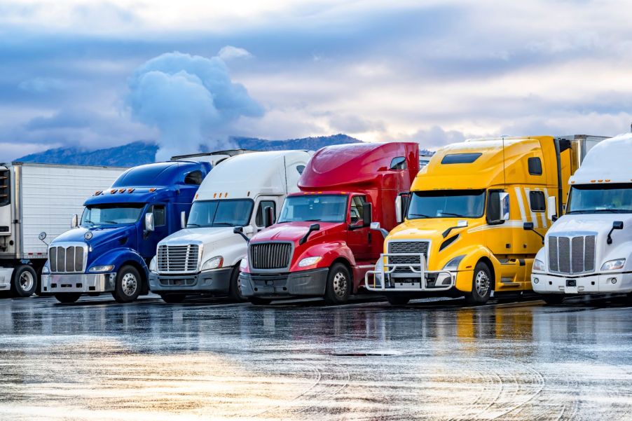 Diesel trucks lined up in a row on a rainy afternoon