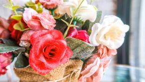 fake flowers in a woven sack made to resemble a basket