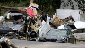 Flood-damaged cars lay piled up in Buncombe County, NC in Hurricane Helene aftermath