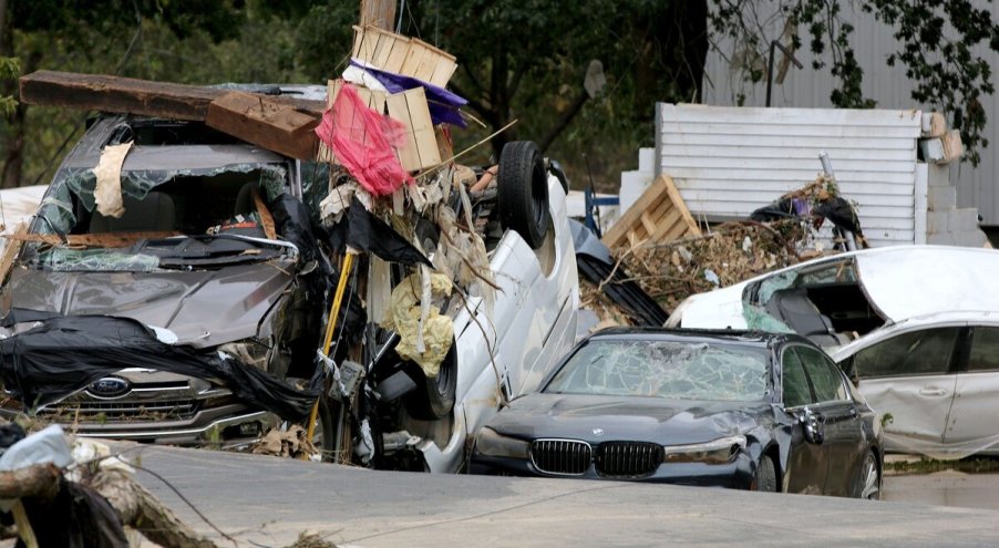 Flood-damaged cars lay piled up in Buncombe County, NC in Hurricane Helene aftermath