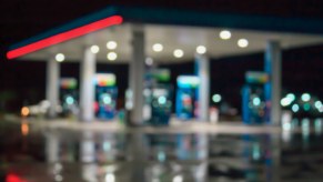 A blurred image of a gas station at night