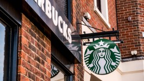 A Starbucks sign on a brick wall