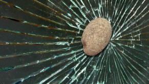 A rock smashing through glass