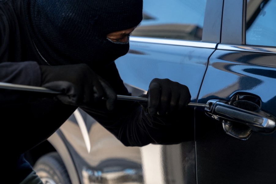 A thief breaking into a truck