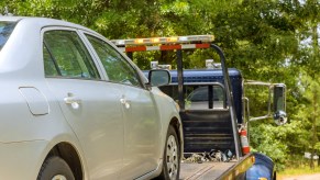 A tow truck with a car on the back