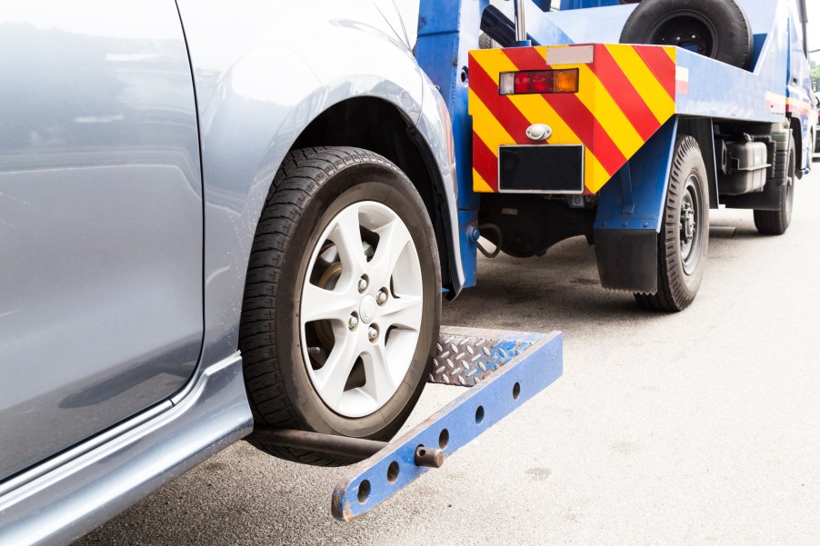 A car being picked up by a tow truck