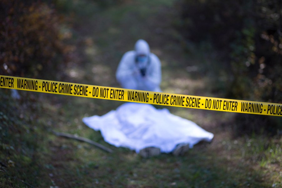 A cop investigating a murder at a crime scene