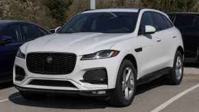 A white Jaguar F-Pace SUV parked backed into a parking spot