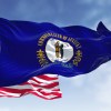 The blue kentucky state flag in front of the U.S. national flag