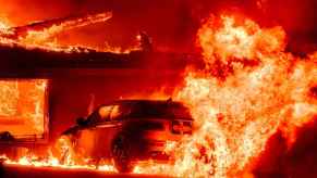 A car on fire during the Los Angeles County fires of 2025