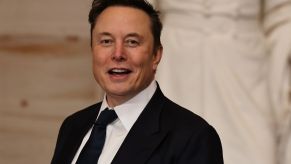 Elon Musk smiling in the direction of a zoomed-in camera