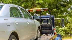 A car on the back of a tow truck