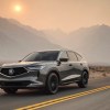 A 2023 Acura MDX driving at dusk