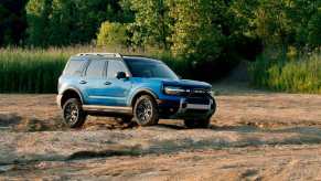 The 2025 Ford Bronco Sport drives on a dirt track.