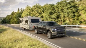 A 2025 Ford F-150 towing an RV on the road