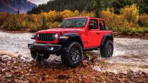 The 2025 Jeep Wrangler off-roading near a creek