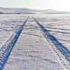 Tire tracks through snow from an AWD SUV winter drag race test.