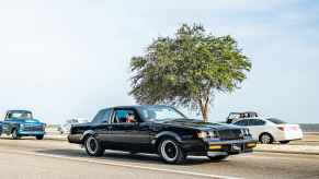 Black Buick Grand National "GNX" trim driving down a highway