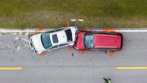 A vehicle crash between a used SUV model and a smaller car.