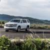 A Chevrolet Tahoe LTZ drives on a rural highway.