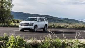 A Chevrolet Tahoe LTZ drives on a rural highway.