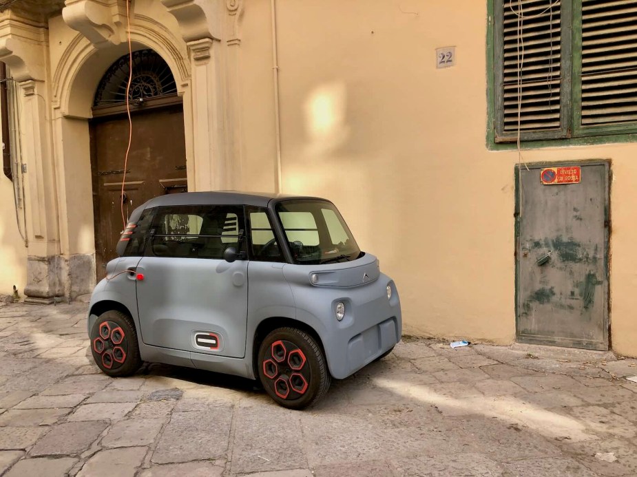 Light blue Citroen compact car parked on a. cobblestone street in Italy.