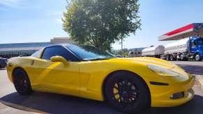 Bright yellow Corvette parked at a gas station.