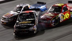 NASCAR trucks in a race on the track