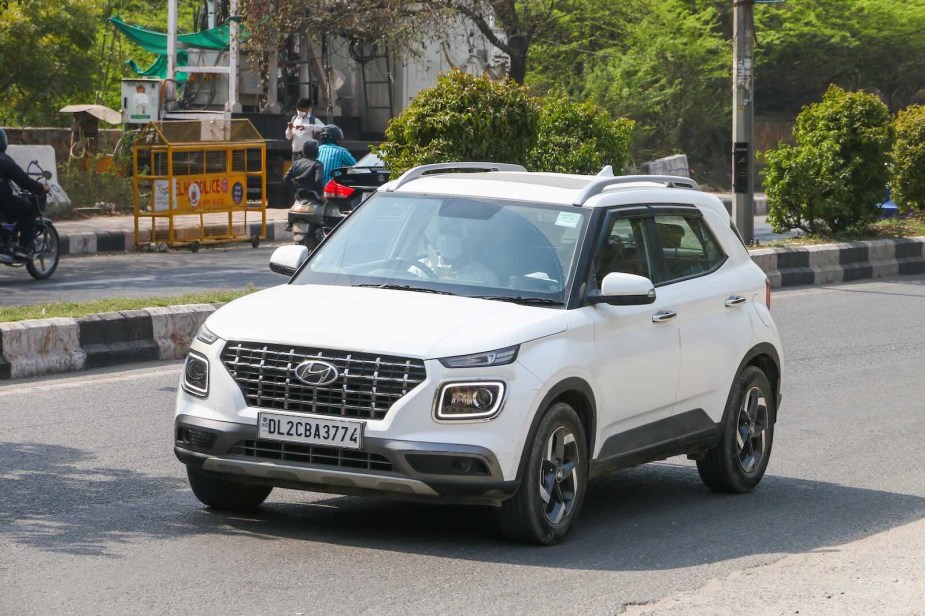 White Hyundai compact crossover--the most dangerous vehicle--driving on a city street in India.