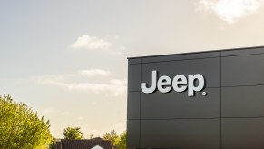 Jeep logo high on the wall of a dealership.