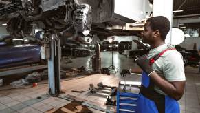 A mechanic works on open recalls in a shop.