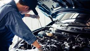 A certified mechanic checks the oil on a high-mileage car.