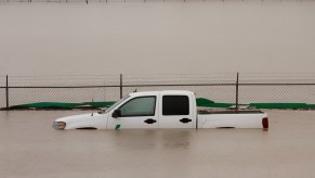 White pickup truck submerged in floodwaters