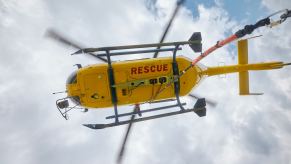 A rescue helicopter prepares to rescue a horse and rider.