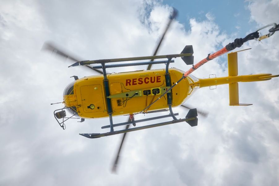 A rescue helicopter prepares to rescue a horse and rider.