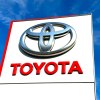 The Toyota logo and name on a large white sign outside a Toyota/Lexus dealership