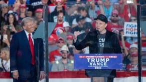 Donald Trump and Elon Musk at a campaign rally before cutting jobs across the government.