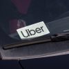 An Uber driver uses a tiny placard to alert passengers.