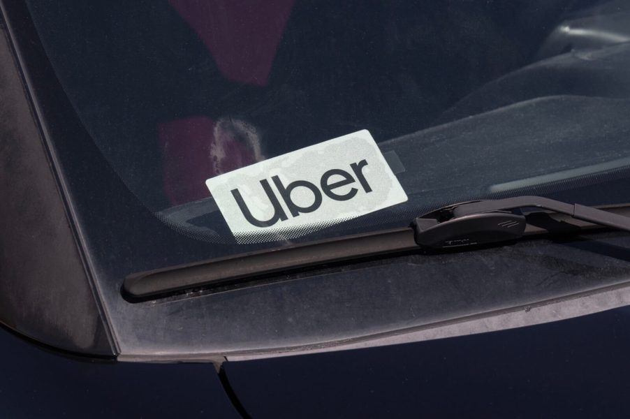 An Uber driver uses a tiny placard to alert passengers.