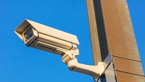 Police speed camera in front of a blue sky.