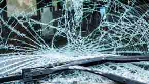 A Rhode Island woman suffered a head injury while driving in the snow after a block of ice crashed through her windshield.