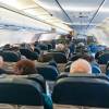 Airplane passengers sitting in rear view