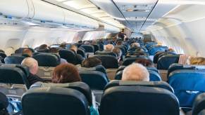 Airplane passengers sitting in rear view