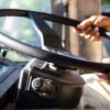 A bus driver with his hands on the steering wheel