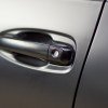 Car door spray-painted flat black in close view of the handle