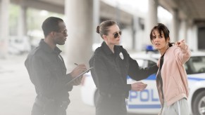 A woman talking to two police officers