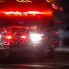 An ambulance at night, driving with its lights on