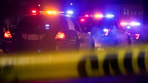 Police cars at a crime scene at night