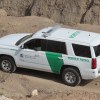 A Customs and Border Protection SUV on a dirt road